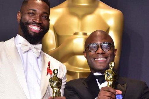 Out gay playwright/screenwriter Tarell Alvin McCraney and director/screenwriter Barry Jenkins accept the Oscar for Best Adapted Screenplay at the 2016 Academy Awards on Sunday, February 26, 2017. 
