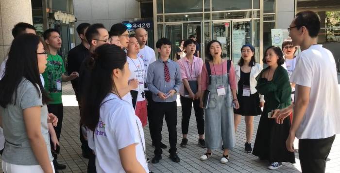 The Beijing Queer Chorus street singing in Seoul Korea in May 2017. Image from a video by Eric Lane Barnes
